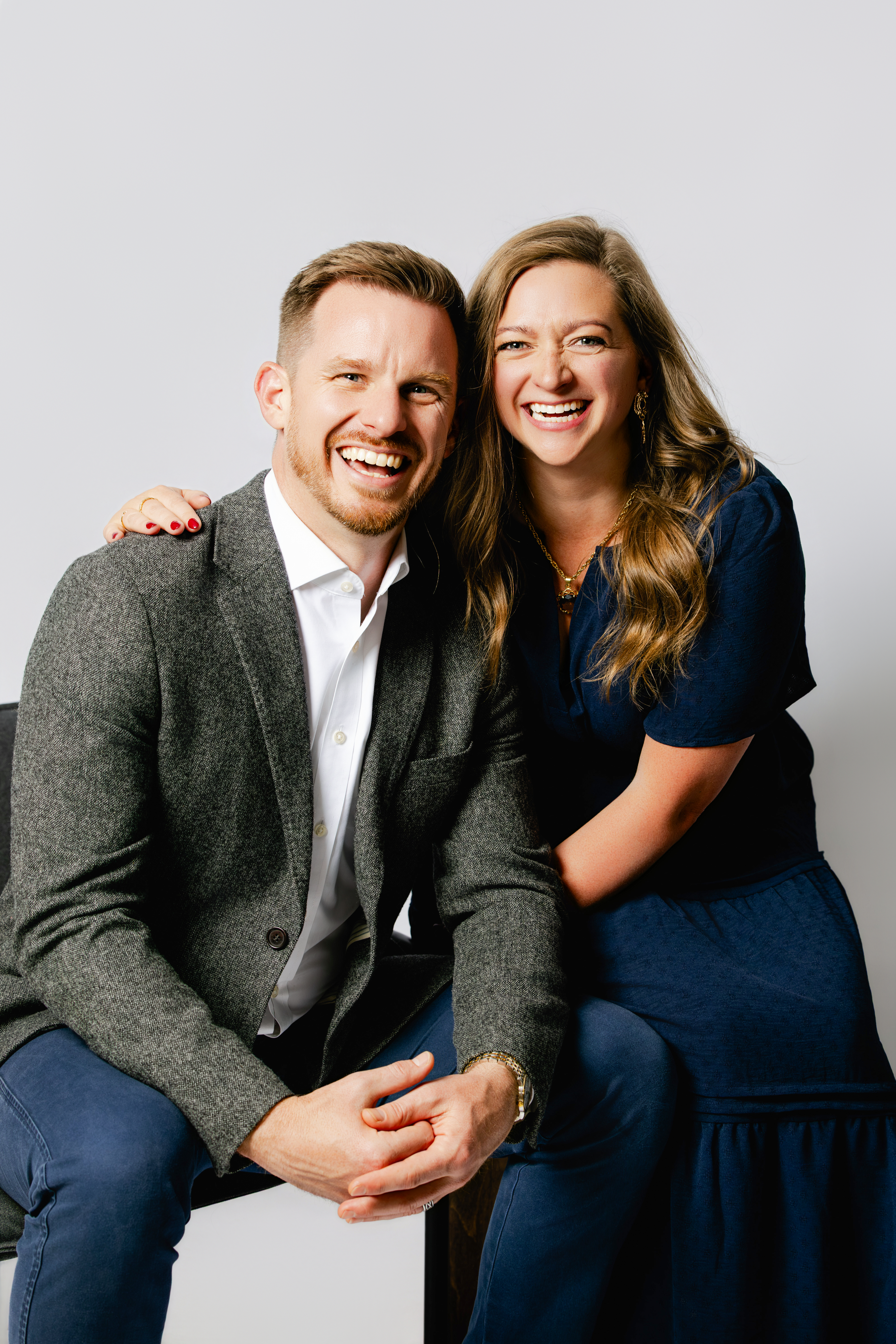 Ashley and Calum Gordon laughing together in the studio; partners in Blueprinted Collective.